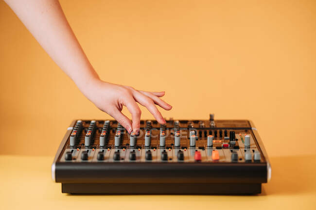 Crop hand of woman using equalizer in music studio on blurred background — Stock Photo