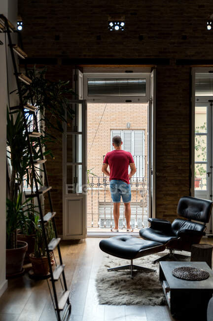 Вид ззаду Розслаблений чоловік у домашньому вбранні, що стоїть на балконі — стокове фото