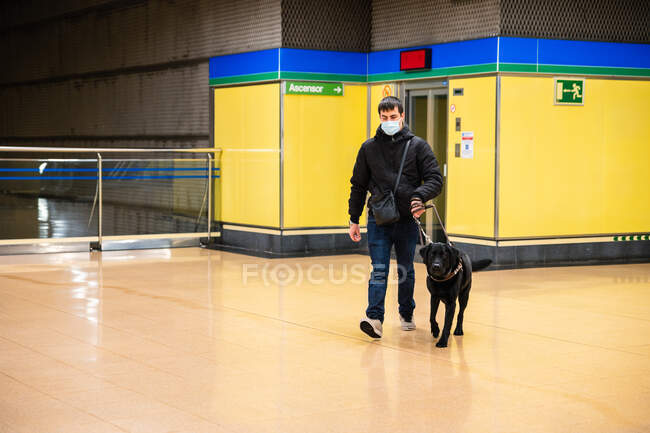 Blind man walking with guide dog in subway — Stock Photo