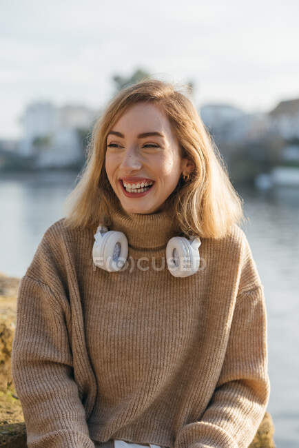 Delighted female sitting in the river and laughing — Stock Photo