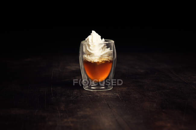 Closeup of a glass of tea with a little cream — Stock Photo