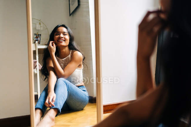 Morena de cabelos compridos Mulher asiática olhando no espelho — Fotografia de Stock