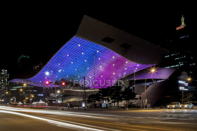 BUSAN - JUNE 21, 2018: Exterior of city street with glowing lights on Busan Cinema Center located in modern district — Stock Photo