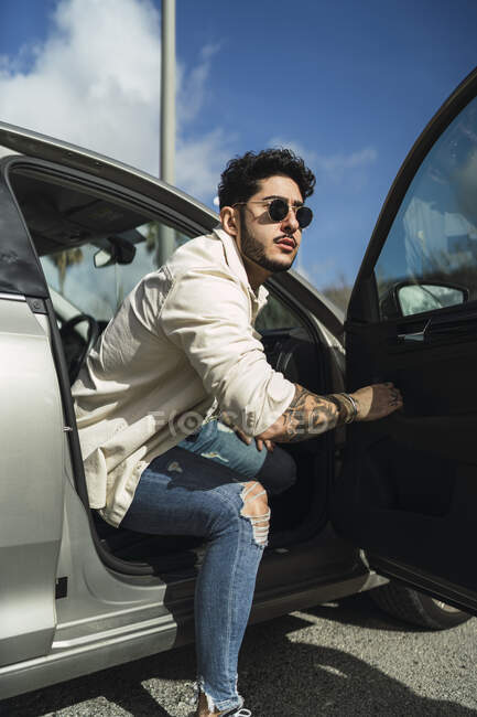 Caucasian man getting out of modern car — Stock Photo