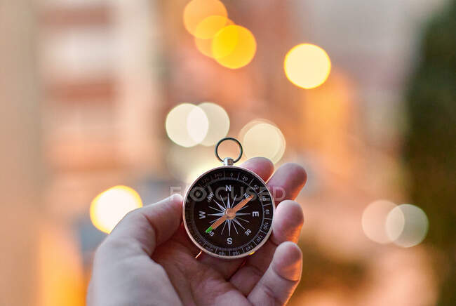 Closeup of hands holding a compass — Stock Photo