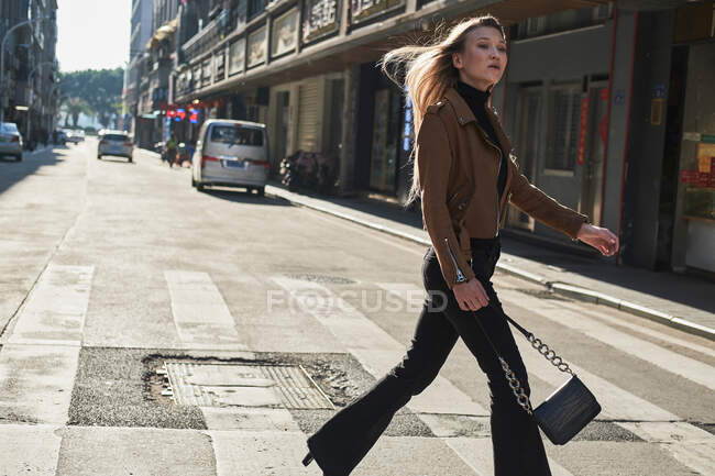 Beautiful blond young girl walking around Chinese downtown — Stock Photo