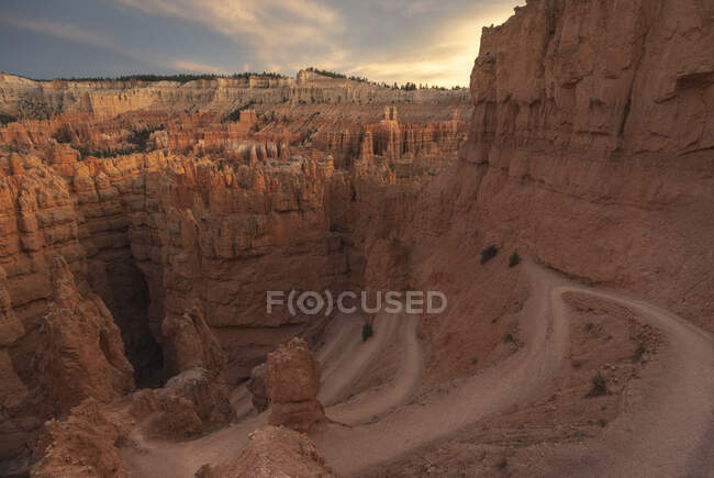 Drone view of amazing landscape of rough cliffs located in arid area in national park in Bryce canyon against cloudy sky — Stock Photo