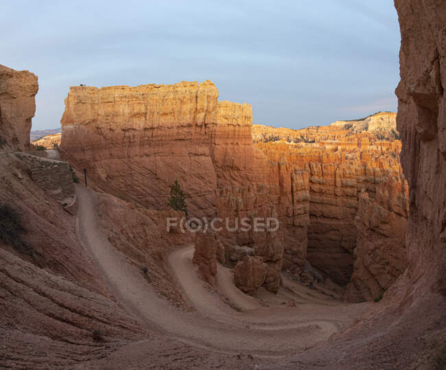 Drone view of amazing landscape of rough cliffs located in arid area in national park in Bryce canyon against cloudy sky — Stock Photo