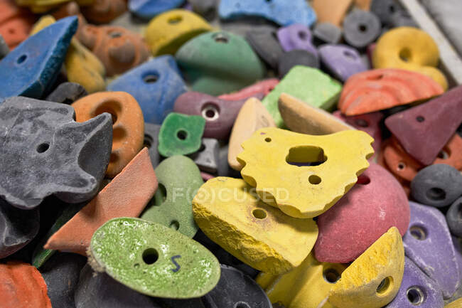 High angle of various types and colors of climbing holds in modern gym — Stock Photo