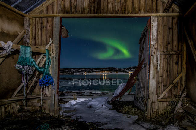 Von der Holzhütte Nordsee bei Nacht Blick auf den nördlichen Laubwald im Winter unter sternenklarem Himmel mit Polarlicht. — Stockfoto