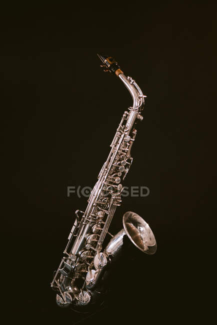 Contemporary classic brass wind instrument saxophone isolated on black background in musical studio — Photo de stock