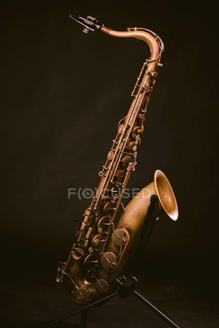 Contemporary classic brass wind instrument saxophone isolated on black background in musical studio — Stock Photo
