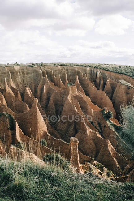Vista panorâmica do desfiladeiro com superfície seca cercada por monte verde no dia ensolarado na Espanha — Fotografia de Stock