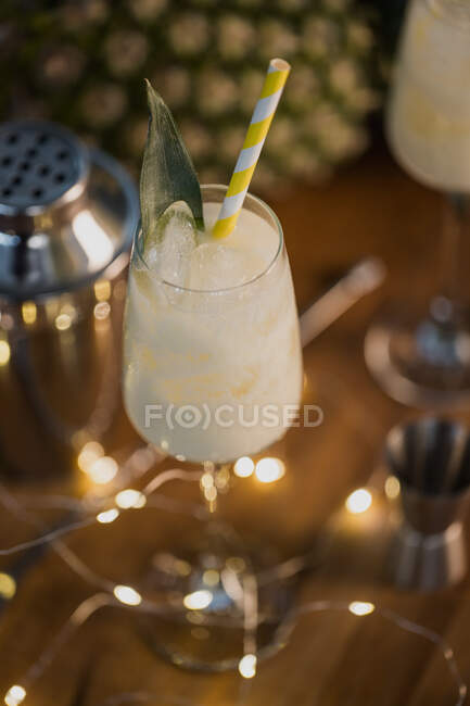 From above composition of sweet classic Pina Colada cocktails served on bar counter near shaker and jigger — Stock Photo