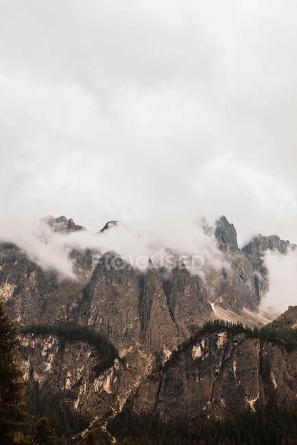 Scenery view of high rough mount with barren terrain on foggy day in Dolomites Italy — Stock Photo
