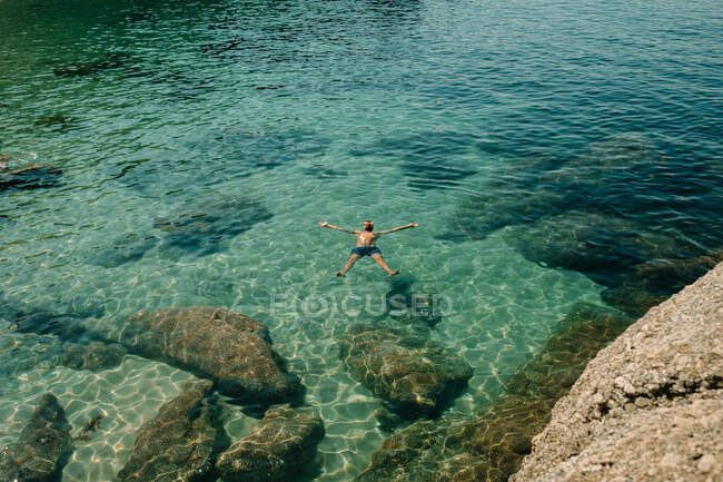 Homme flottant dans la mer pendant l'été — Photo de stock