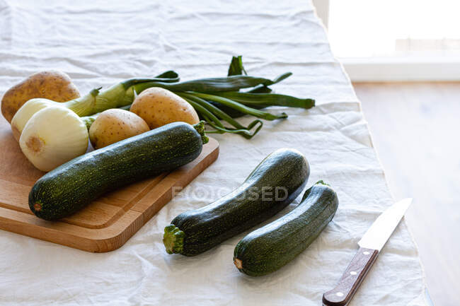High angle of various fresh ingredients prepared for cooking appetizing zucchini cream soup at home — Stock Photo