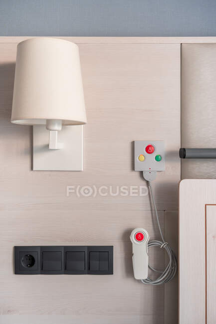 Nurse call system with emergency buttons installed near bed in medical room in hospital — Stock Photo