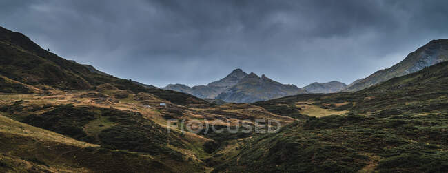 Paisagem do vale de Aran com majestosas colinas verdes e céu sombrio cinza escuro acima — Fotografia de Stock