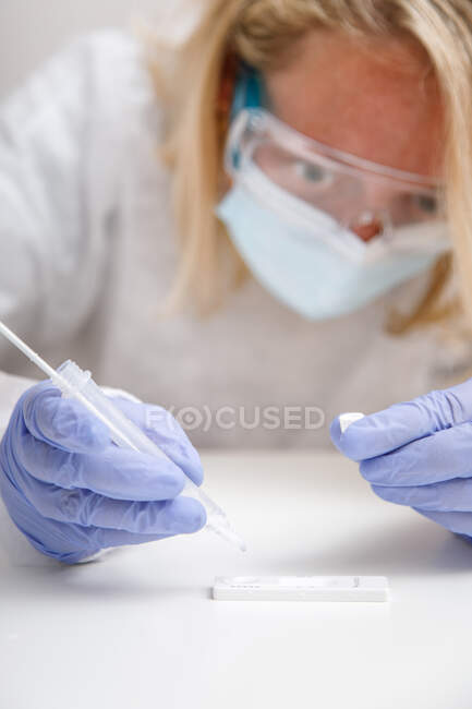 Female doctor analyzing a CRP test of a senior patient — Stock Photo