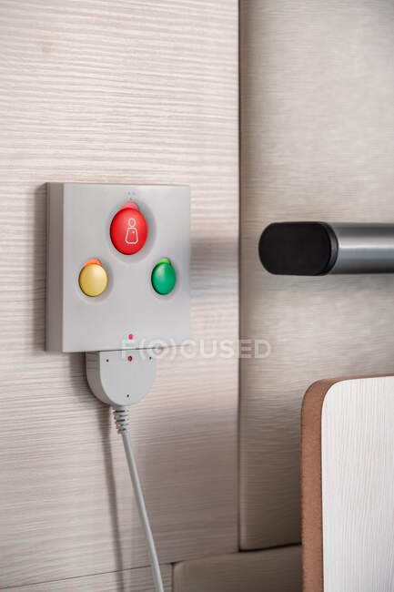 Close up of nurse call system with emergency buttons installed near bed in medical room in hospital — Stock Photo