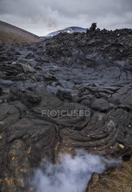 Gros plan solidifié magma rivières du volcan Fagradalsfjall en Islande par une journée nuageuse — Photo de stock