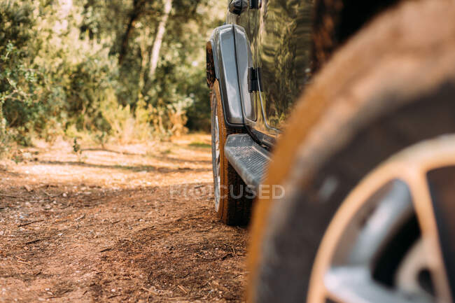 View of an off-road car wheel on a road on a sunny day — Stock Photo