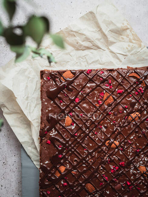 Closeup of a piece of chocolate bar with raspberry on a table — Stock Photo