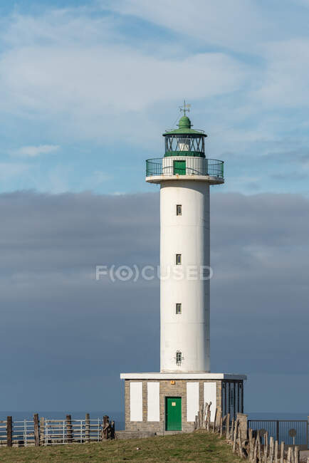 White lighthouse placed in Faro de Lastres in Asturias in Spain under cloudless blue sky in daytime — Stock Photo