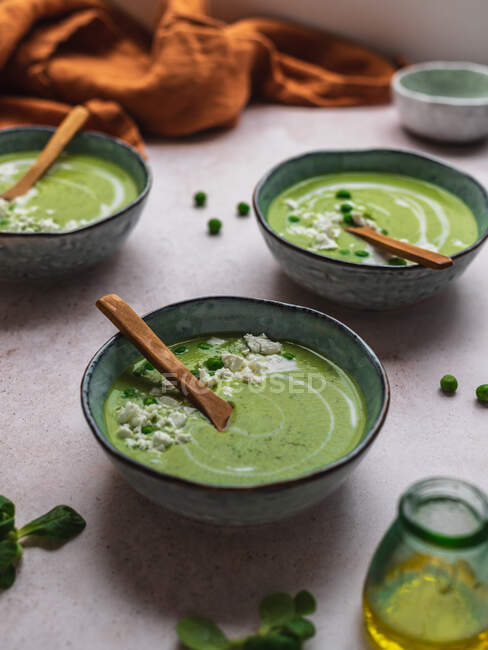 From above of delicious pea cream soup in bowls served on table — Stock Photo