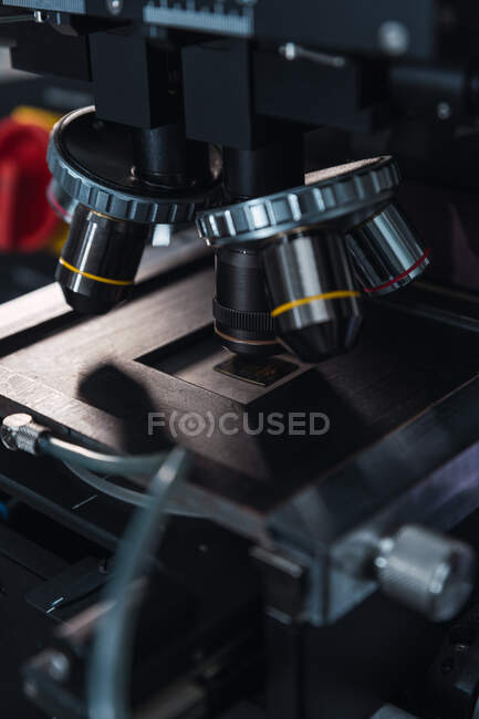 Contemporary professional microscope with powerful lenses placed on table in modern equipped lab — Stock Photo