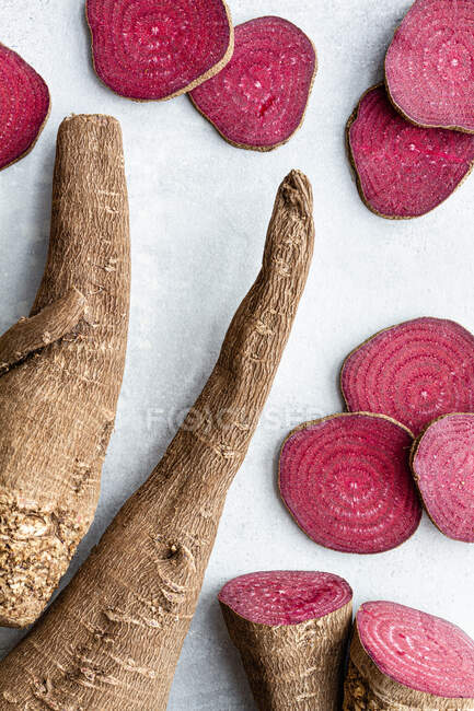 Overhead composition of organic natural beetroot cut into slices and arranged on white surface — Stock Photo