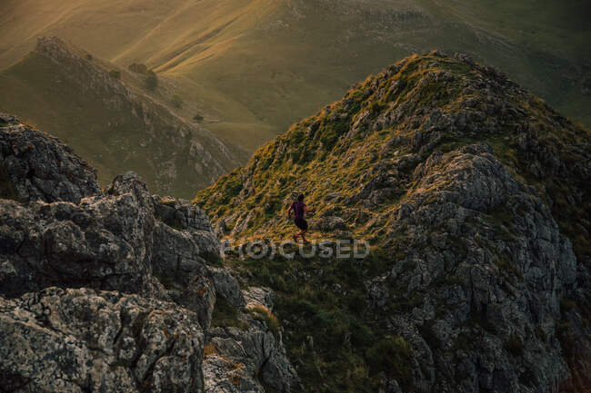 From above of anonymous tourist on top ridge of cliff above mountain valley in Spain — Stock Photo