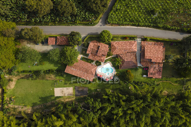Aerial top view of contemporary hotel houses with outdoor swimming pool surrounded by verdant tropical greenery in Armenia Colombia — Fotografia de Stock