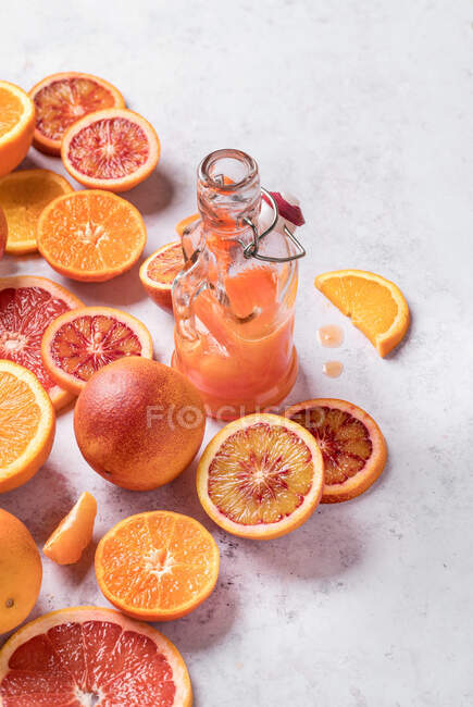 From above sanguine fruit on white table cut into half parts — Stock Photo