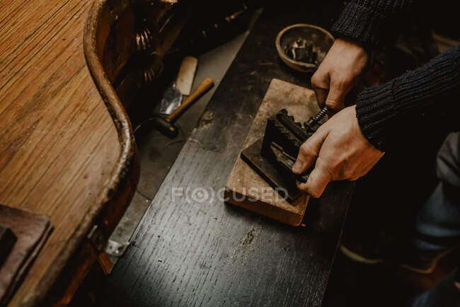 Ourives masculinos usando ferramenta manual para moldar anel de metal na oficina — Fotografia de Stock