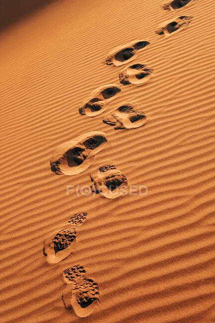From above of footsteps on texture of brown sand in hot desert in Morocco — Stock Photo