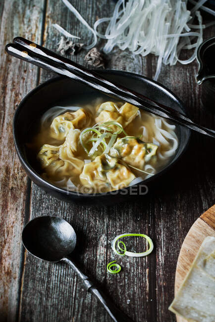 From above wonton soup on a wooden table — Stock Photo