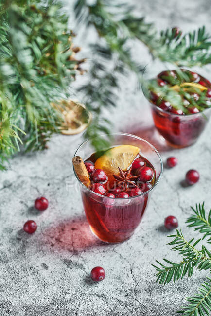 From above of glasses with cranberries with lemon next to Christmas decoration — Stock Photo