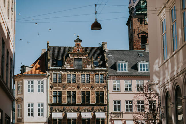 Facade of typical residential buildings with tile roofs located in historic district of Copenhagen — Stock Photo