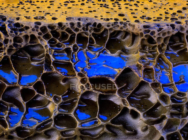 Грубый текстурированный фон осадочных пород синего и желтого цветов с неровной поверхностью — стоковое фото