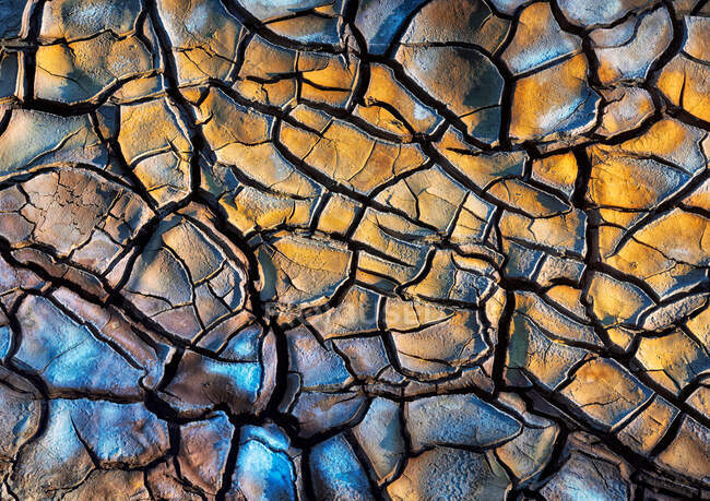 Top view of textured background of dry uneven surface with cracks in desert — Stock Photo