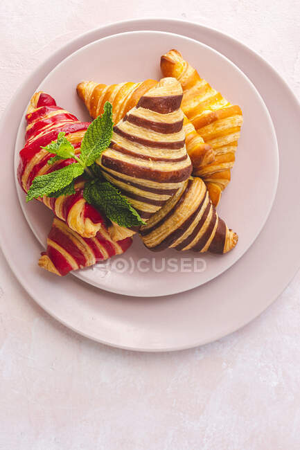 De dessus de croissants sucrés assortis servis dans le panier sur la table pour le petit déjeuner — Photo de stock