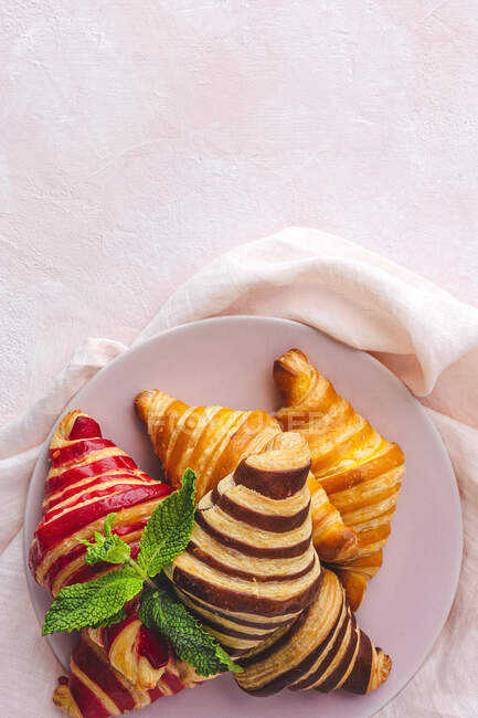 From above of assorted sweet croissants served in basket on table for breakfast — Stock Photo