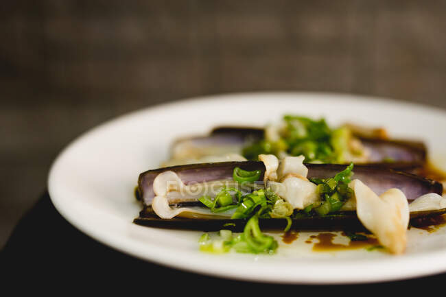 Dish with delectable razor clams in restaurant — Stock Photo