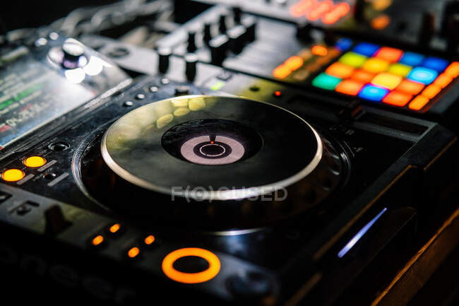 From above professional two channel DJ controller for performances including music improvisation at concert in modern night club — Stock Photo