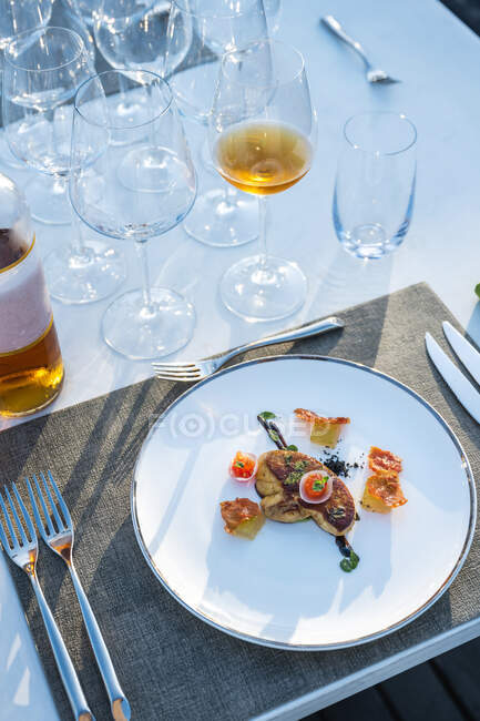 Delicious and well garnished fried goose liver dish at outdoor high cuisine restaurant — Stock Photo