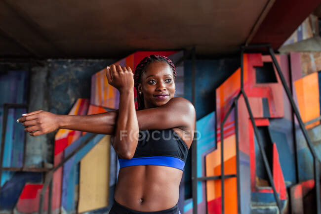 Ethnic woman stretching arms — Stock Photo
