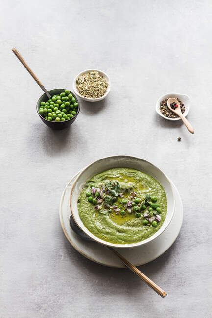 From above, delicious peas cream over concrete white table — Stock Photo
