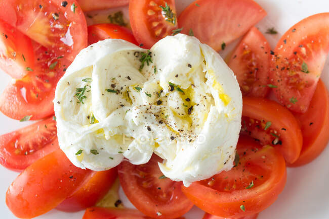 From above closeup of ripe tomato slices and mozzarella cheese served on white plate — Stock Photo
